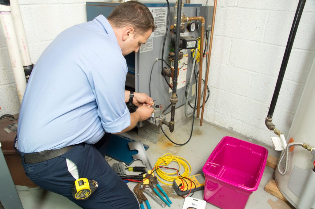 Technician repairing a furnace